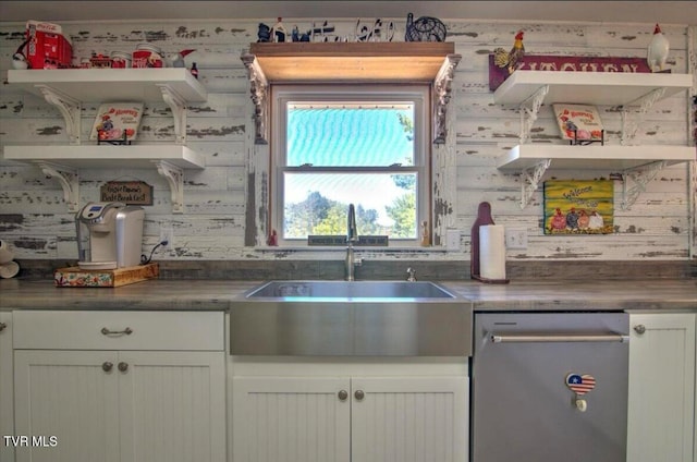 kitchen featuring dishwasher, white cabinetry, and sink