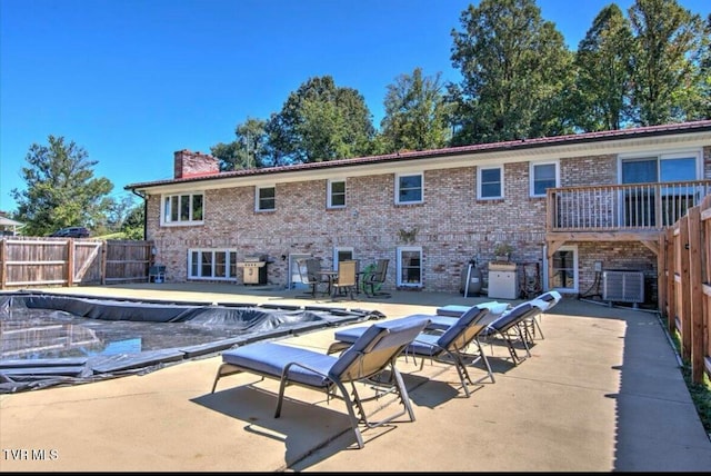 view of pool featuring a patio and central air condition unit