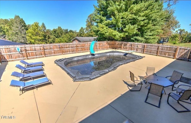 view of swimming pool featuring a patio area