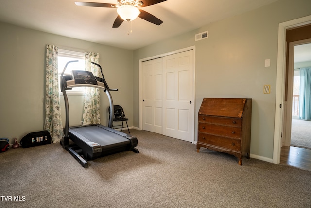 workout room with ceiling fan and carpet