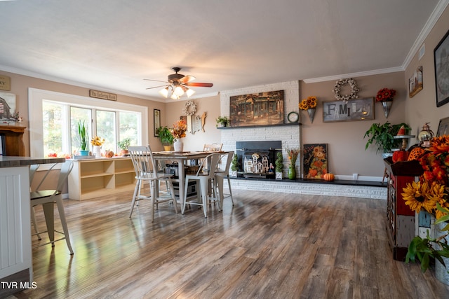 dining room featuring hardwood / wood-style flooring, ceiling fan, and ornamental molding