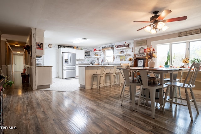 dining area featuring hardwood / wood-style flooring, ceiling fan, and crown molding