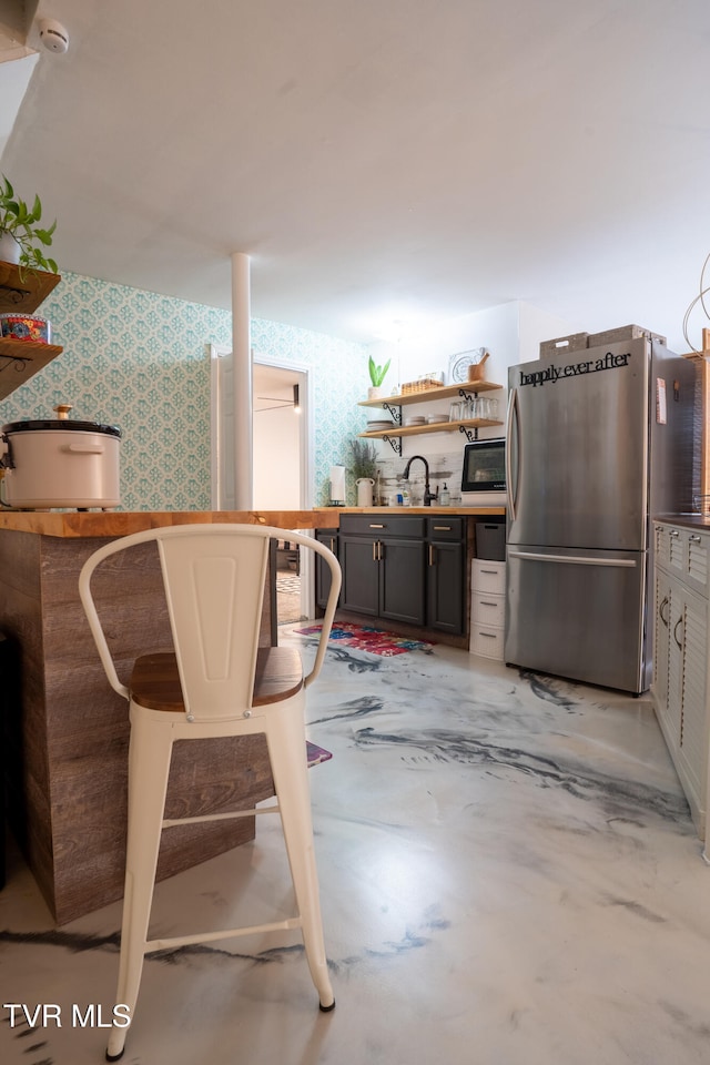 interior space featuring stainless steel fridge and sink