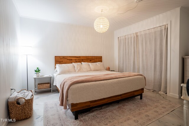 bedroom with a chandelier and ornamental molding