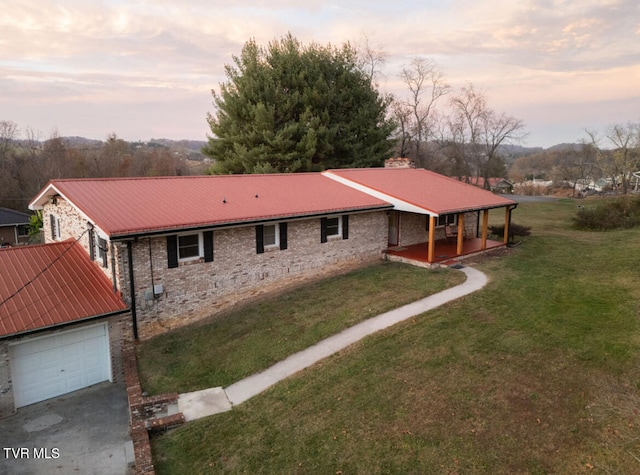 exterior space with a yard and a garage