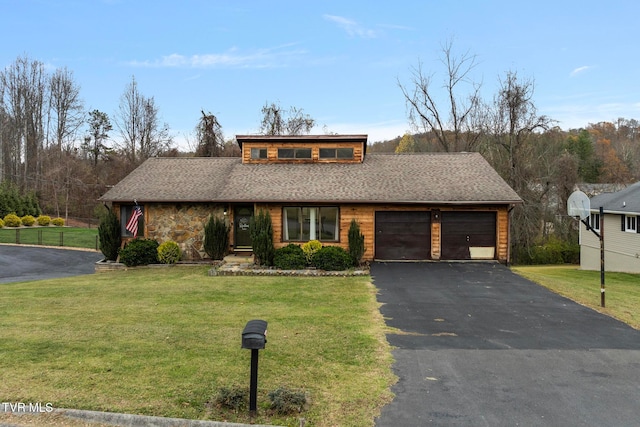 view of front of house with a garage and a front lawn