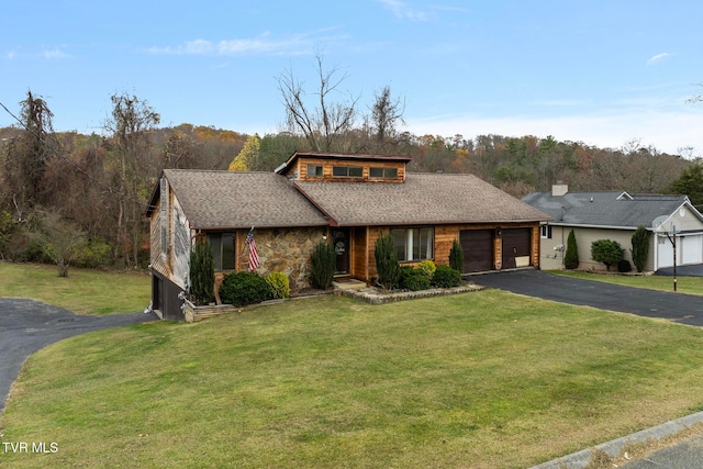 view of front of home with a front lawn and a garage