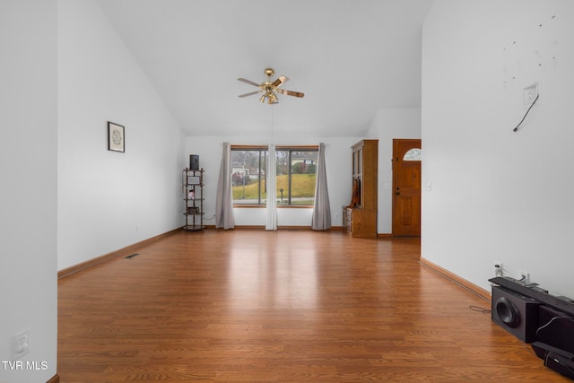 unfurnished living room featuring hardwood / wood-style floors, ceiling fan, and lofted ceiling