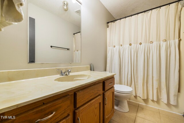 full bathroom featuring vanity, tile patterned floors, toilet, a textured ceiling, and shower / tub combo