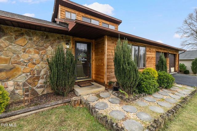 view of exterior entry with a garage