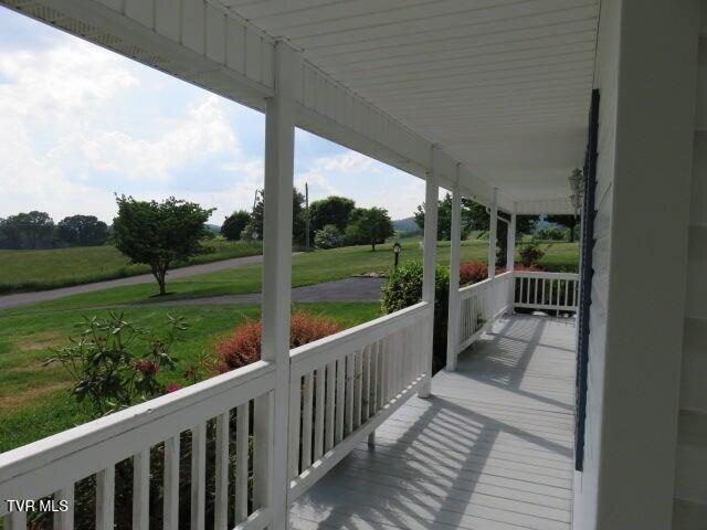 wooden terrace with a porch