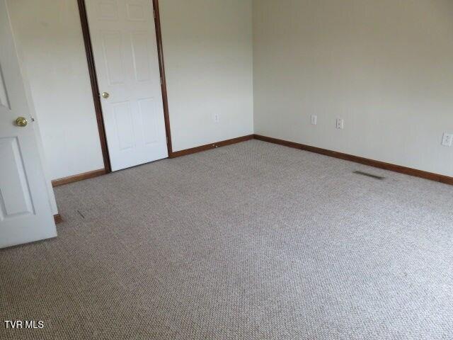 unfurnished bedroom with light carpet