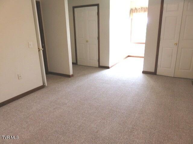 unfurnished bedroom with light colored carpet