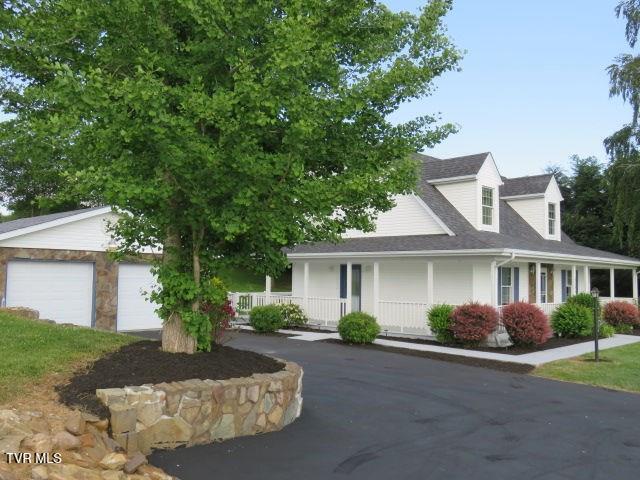 view of front of home with a porch and a garage