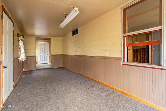 1667 Bristol Caverns Hwy, Bristol, TN 37620 - carpeted spare room featuring a wainscoted wall and wood walls