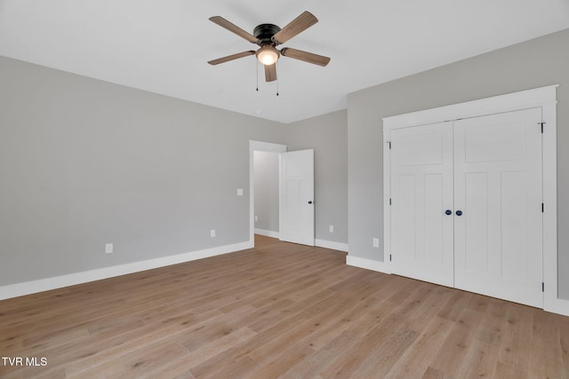 unfurnished bedroom featuring a closet, ceiling fan, and light hardwood / wood-style flooring