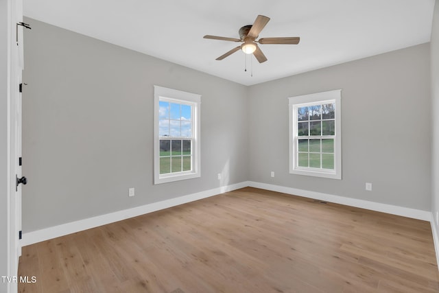 empty room with light hardwood / wood-style flooring and ceiling fan