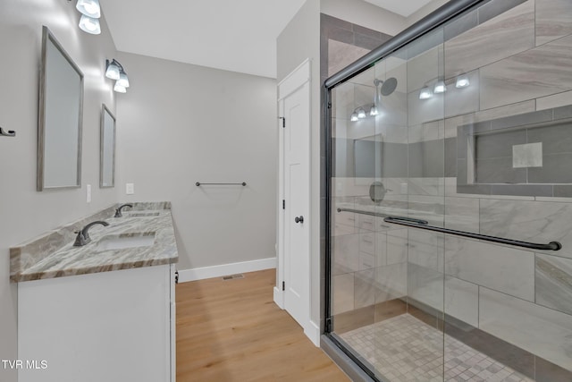 bathroom featuring vanity, hardwood / wood-style flooring, and an enclosed shower