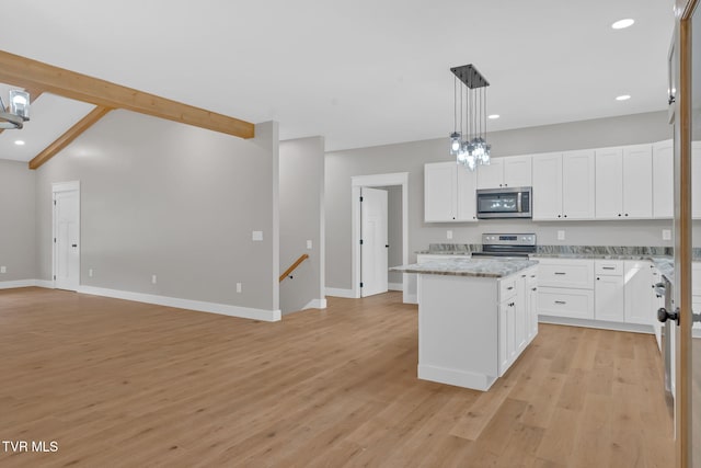 kitchen featuring stainless steel appliances, white cabinetry, and a kitchen island