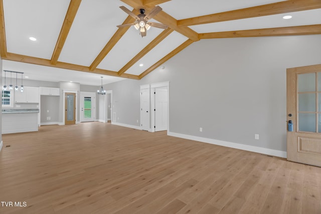 unfurnished living room featuring beamed ceiling, ceiling fan with notable chandelier, light hardwood / wood-style floors, and high vaulted ceiling