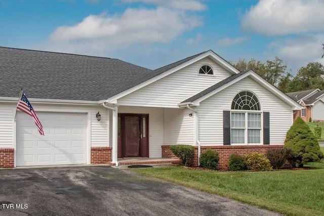 ranch-style house with a front lawn and a garage