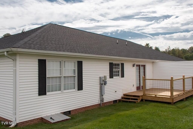 rear view of house with a yard and a wooden deck