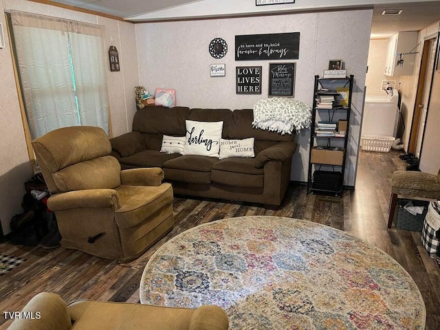 living room featuring washer / clothes dryer, dark hardwood / wood-style floors, and crown molding