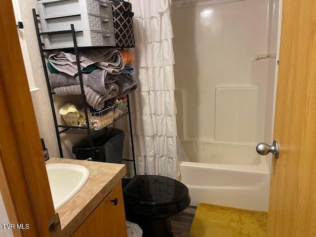 full bathroom featuring vanity, toilet, shower / bathtub combination with curtain, and hardwood / wood-style flooring