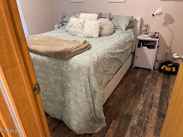 bedroom featuring dark hardwood / wood-style flooring