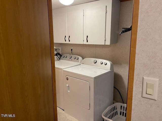 washroom with cabinets and independent washer and dryer