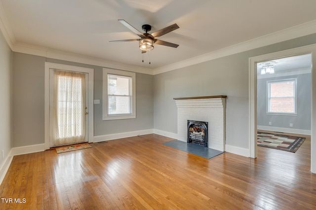 unfurnished living room with light hardwood / wood-style floors, ceiling fan, and crown molding