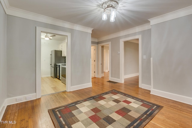 unfurnished room featuring hardwood / wood-style flooring and crown molding