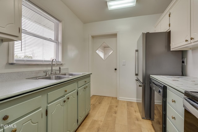 kitchen featuring white cabinetry, sink, stainless steel electric range oven, black dishwasher, and light wood-type flooring