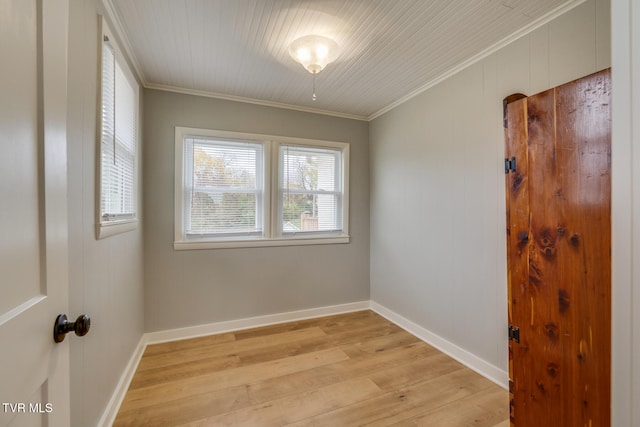 unfurnished room featuring light wood-type flooring and crown molding