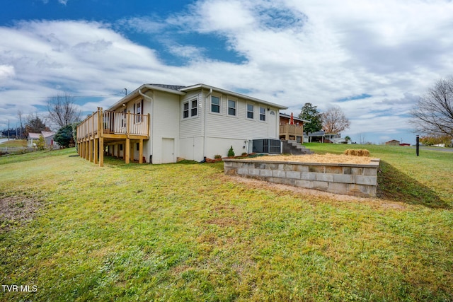 rear view of property featuring central AC, a lawn, and a wooden deck