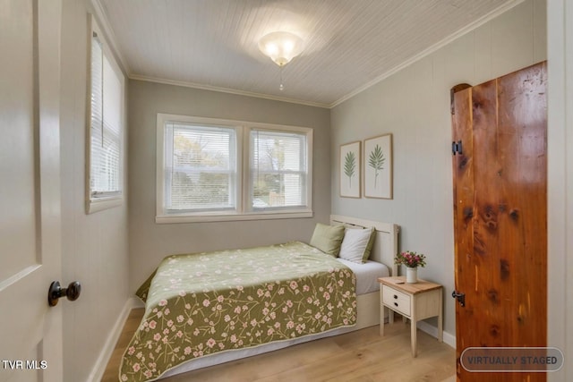 bedroom with crown molding and light hardwood / wood-style floors