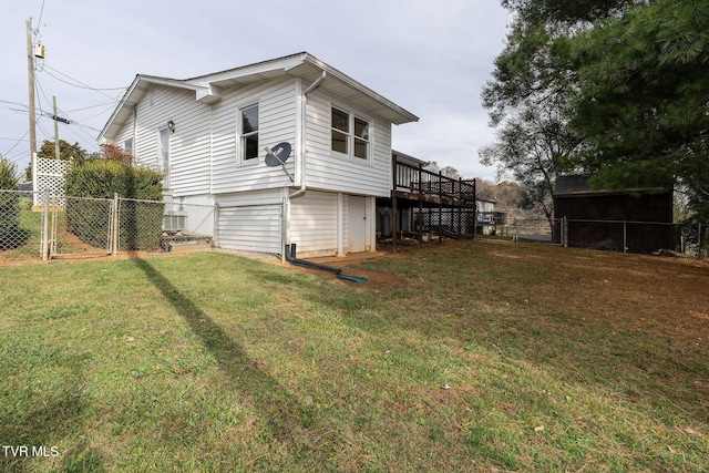 view of side of home featuring a yard and a deck