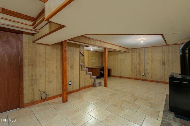 basement featuring wooden walls