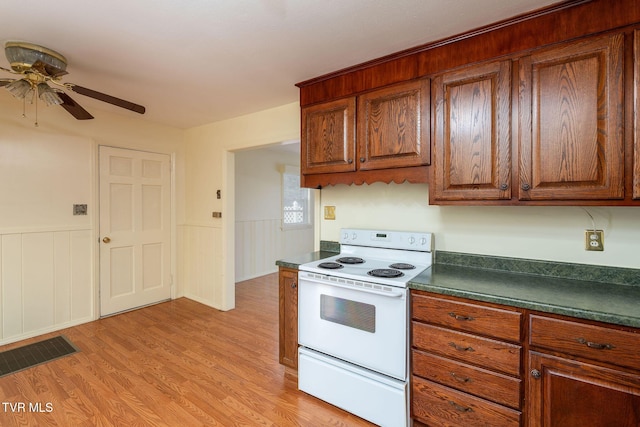 kitchen featuring white range with electric stovetop, ceiling fan, and light hardwood / wood-style floors