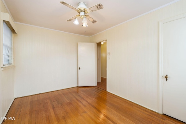 spare room featuring light hardwood / wood-style flooring, ceiling fan, and crown molding