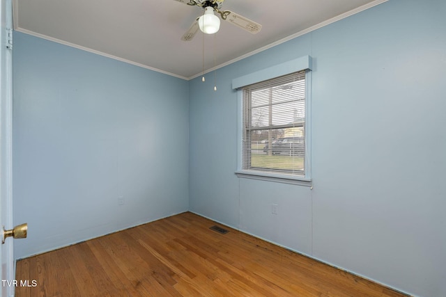 empty room featuring ceiling fan, light hardwood / wood-style flooring, and ornamental molding