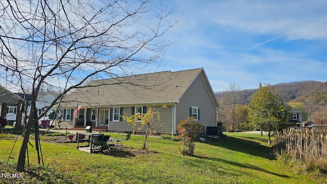 rear view of house with a yard