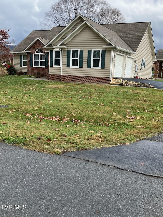 ranch-style house with a garage and a front lawn