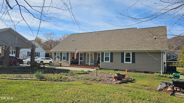 back of house featuring covered porch and a lawn