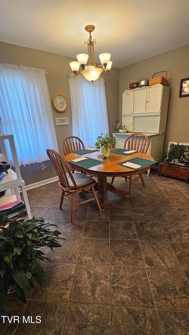 dining area featuring a notable chandelier