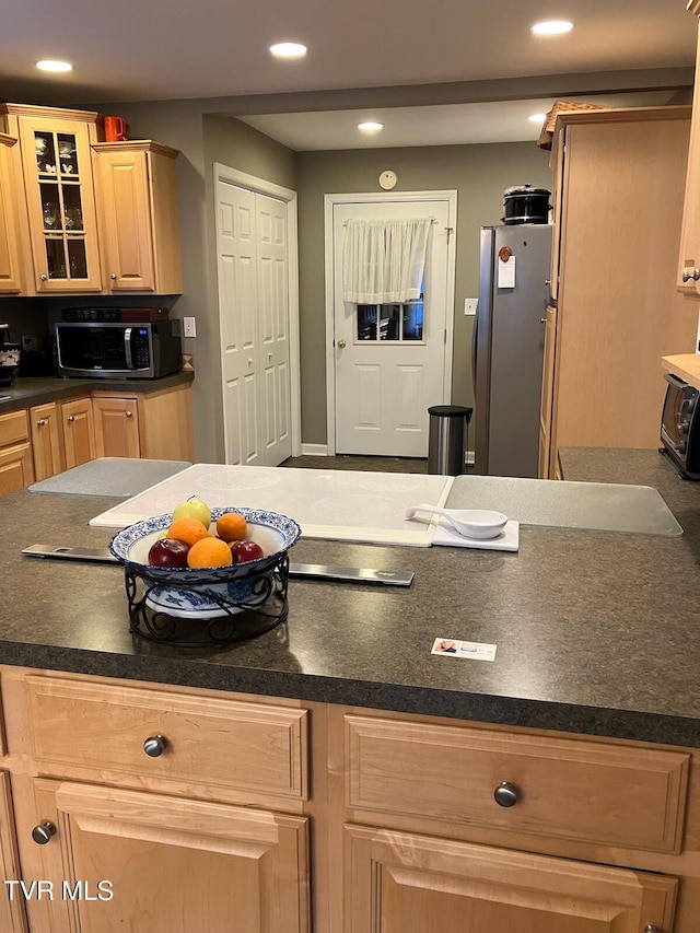 kitchen with light brown cabinets and stainless steel appliances