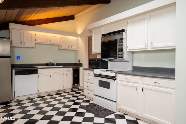 kitchen featuring lofted ceiling, white cabinets, and white appliances