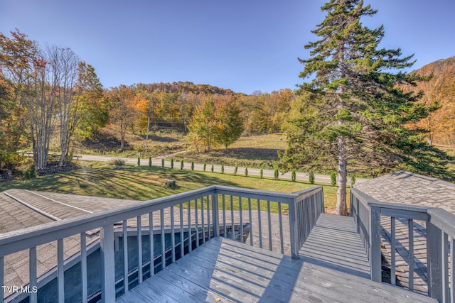 wooden terrace with a lawn