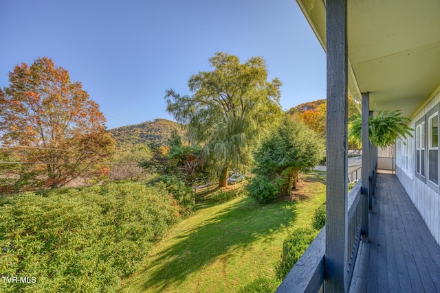 view of yard with a mountain view and a balcony