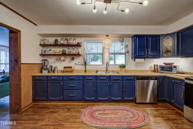 kitchen featuring a wealth of natural light, blue cabinets, dark wood-type flooring, and appliances with stainless steel finishes